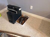 Subwoofer, control unit and box of cables on carpet