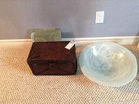 Large glass bowl and antique box placed on carpeted floor, showing size and appearance