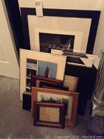 Full lot of picture frames stacked together showing variety in sizes and frame types