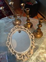Zinc three-arm candelabrum, pair of brass single candle holders, and ornate framed decorative mirror arranged on a bubble wrap surface. Items shown clearly with the tallest holder at 9.5 inches high.