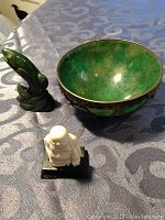 Top view of bowl interior, fish carving, and Buddha statue