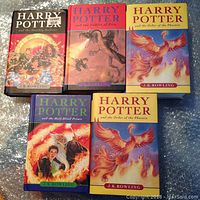 Front covers of five hardcover Harry Potter books by J.K. Rowling showing colorful illustrated dust jackets.