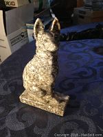 Front view of the stone German Shepherd dog sculpture showing the mottled coloration and detailed carving.