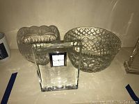 Photo of the Waterford crystal clock and two crystal bowls together showing size and shape