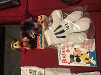 Overview photo showing all items: Pluto plush, donkey plush, Mickey gloves, and Birthday Book
