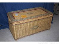 Closed wicker trunk showing woven pattern and wooden lid top