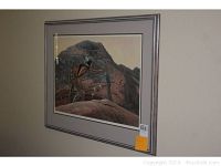 Framed Western art print signed by Richard Luce showing a Native American figure and rock art.