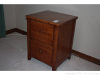 Single wooden 2-drawer file cabinet showing front and side views, includes wooden knob handles and medium brown finish.