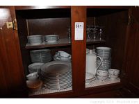 Full view of Noritake Buckingham china displayed in cabinet. Includes stacked dinner plates, salad plates, bread plates, cups and saucers and a coffee pot.