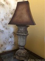Overall front view of La-Z-Boy decorative table lamp showing full lamp and shade against floral wall background.