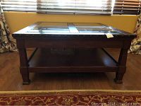 Front view of the square La-Z-Boy coffee table showing wooden frame, glass inset top with four glass panels and a lower shelf.
