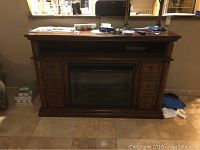 Full frontal view of electric fireplace with wooden mantel, showing integrated electric insert and side drawers.