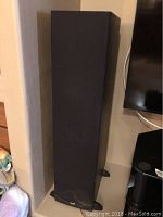 Front view of one floorstanding speaker with fabric grille and Klipsch logo
