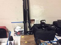 Overall view of camera body, flash unit, tripod, carrying case and box