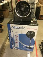 Newair 18 inch outdoor misting fan in box shown alongside small Ozeri fan on top