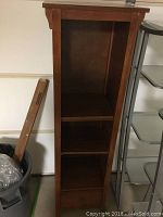 Front view of the wooden shelf showing missing middle shelf and single bottom drawer.