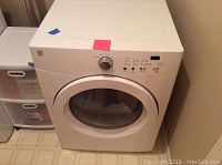 Full front view of white front-loading dryer