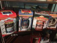 Rows of Budweiser beer steins in original holiday-themed boxes with colorful graphics and labels