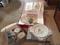 Overview of the boxed set showing plates, cups, platter, and Santa figurine