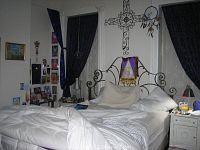 Full bed assembled with bedding to show frame assembled and setup in a room environment.