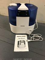 Venta Sonic humidifier front view with user manual placed in front.