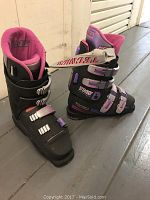 Pair of Technica women's ski boots size 7.5 shown side by side, left boot missing front buckle.