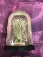 Front view of Empire State Building snowglobe showing detailed miniature building and base text
