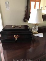 Photo of the wooden jewelry box and Waterford Crystal lamp on wooden surface