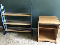 Photo of child's shelf with surfboard design, three shelves with striped cream and wood tones, blue frame.