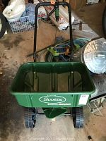 Photo of a green Scotts 3000 spreader showing front and handle parts