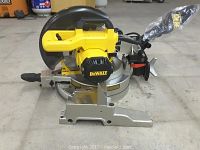 Front view of DeWalt miter saw showing motor housing, blade guard and base