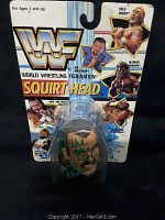 Full packaged view showing WWF logo, wrestler images, and the figurine inside the packaging.