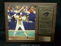 Wooden plaque with color action photo of Roberto Alomar batting, his autograph in blue ink, and engraved metal information plates.