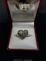 Front angled view of the 925 silver heart-shaped ring in its display box, showing the textured heart design and the small square stone.