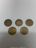 Photo of five Canadian nickels from the 1940s showing obverse and reverse designs, dates 1943, 1945, and 1947