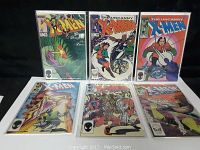 Six X-Men comic books from the Bronze Age laid out in two rows, each in protective plastic sleeves.