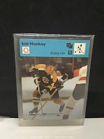 Front of Bobby Orr 1971 Ice Hockey card in protective sleeve showing photo of player skating in Boston Bruins uniform.