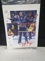 Photo showing the autographed photo of Honky Tonk Man in blue sequined outfit with guitar and wrestling belt.