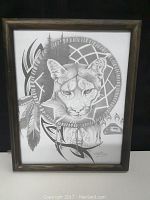 Full view of the framed monochrome Native American style artwork with a cougar's face and dreamcatcher design.