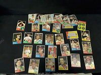 Image showing a spread of approximately 40 vintage baseball cards with various player images, team logos, and statistics.