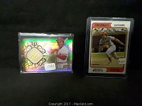 Two Johnny Bench sports cards side by side, one with a game-used bat piece and autograph, the other a classic baseball card.