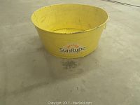 Photo showing front of the yellow vintage metal bin with SunRype logo.