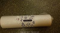 Rolled art print labeled '#7' showing Planet Kid brand wrapping and markings