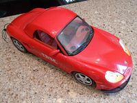 Front angled view showing the red Porsche Boxster model car, visible minor wear on surface.