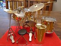 Front view showing the full arrangement of miniature drums, cymbals, and stool.