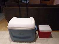 Photo of both coolers side by side showing size difference and exterior features.