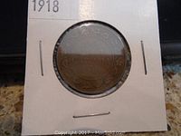 Reverse side of the 1918 Canadian large penny coin displaying the crown, denomination and country name.