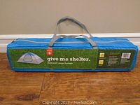 Blue carrying case packaging for dome tent with brand and model details.