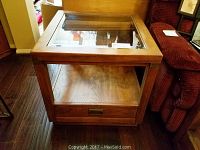 Full view of the Drexel wood and glass end table with drawer and open middle shelf.