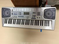 Full top-down view of Casio CTK-593 electric keyboard showing keys, speakers, control buttons, and LCD display.